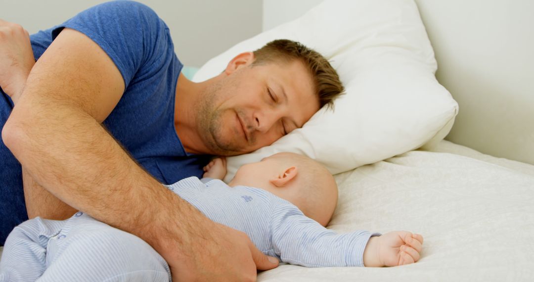 Father Comforting Sleeping Baby in Bed at Home - Free Images, Stock Photos and Pictures on Pikwizard.com