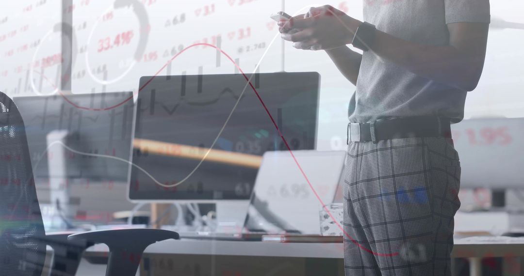 Data Analyst Reviewing Charts on Monitors in Modern Office