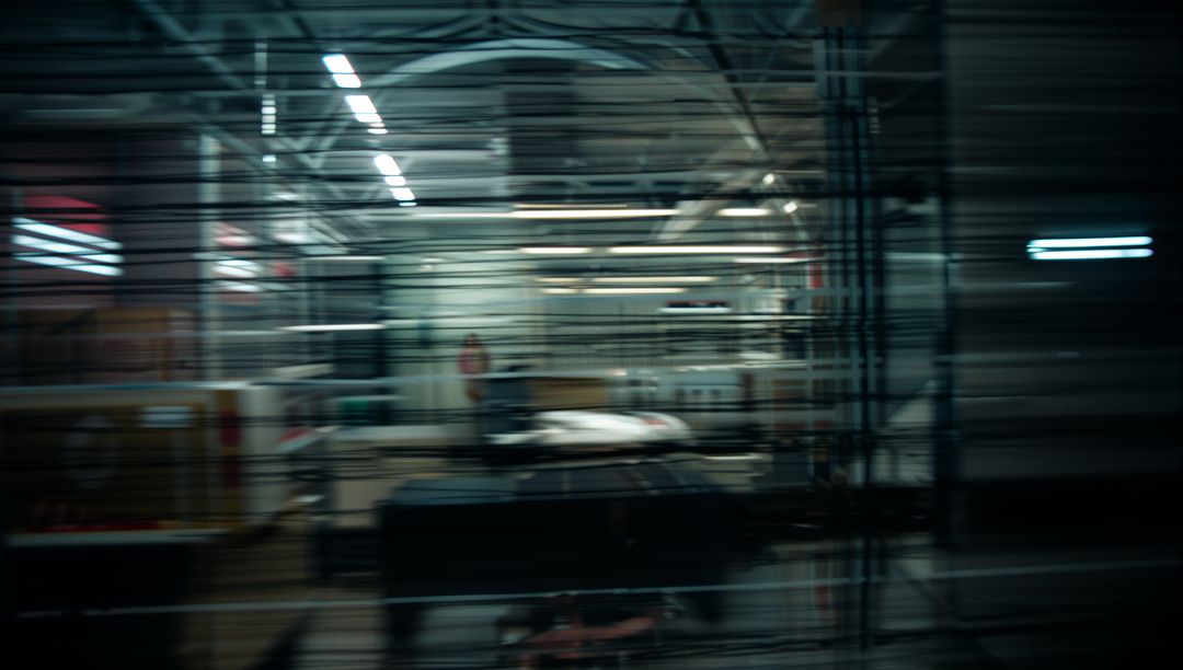 Blurred View Inside Auto Repair Shop Through Shutter Door