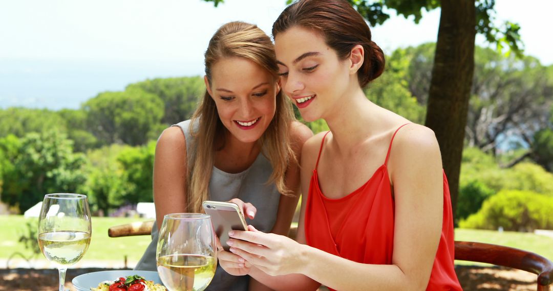 Two Women Enjoying Outdoor Lunch with Wine - Free Images, Stock Photos and Pictures on Pikwizard.com