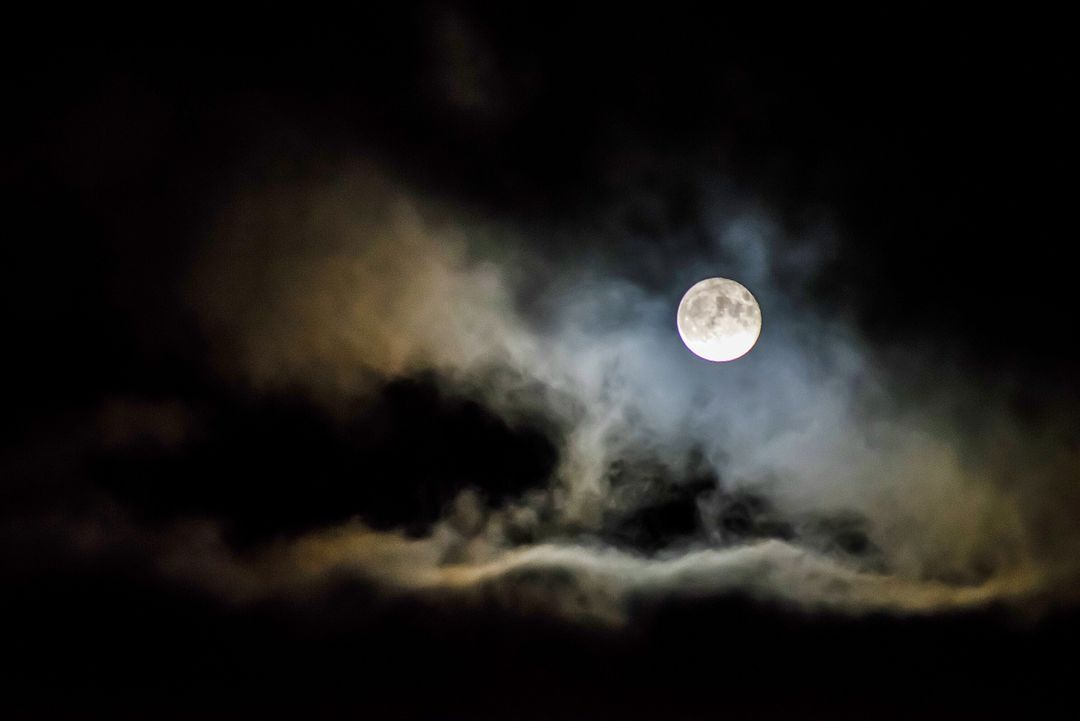 Bright Full Moon Shining Through Dark Clouds in Night Sky - Free Images, Stock Photos and Pictures on Pikwizard.com