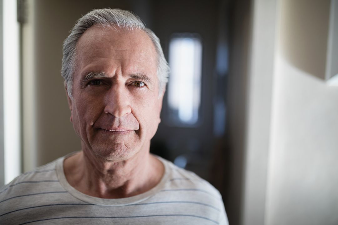 Close-up portrait of senior male patient standing in corridor - Free Images, Stock Photos and Pictures on Pikwizard.com