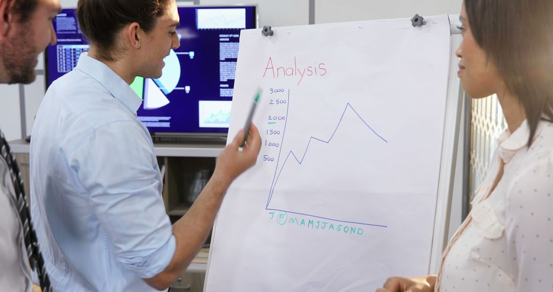 Team Discussing Business Data Analysis Graph during Meeting - Free Images, Stock Photos and Pictures on Pikwizard.com