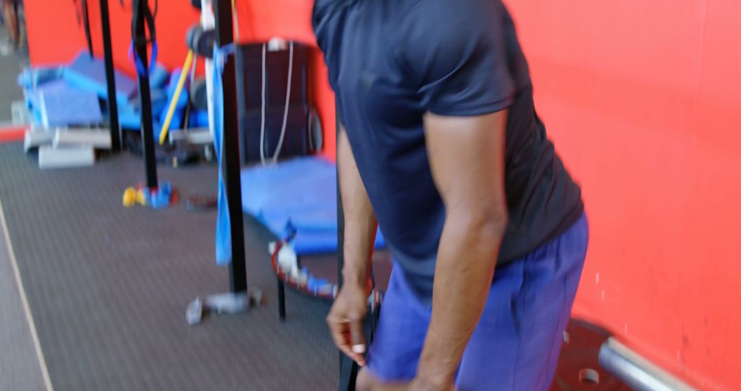 Athlete Preparing for Workout in Gym with Red Wall - Free Images, Stock Photos and Pictures on Pikwizard.com