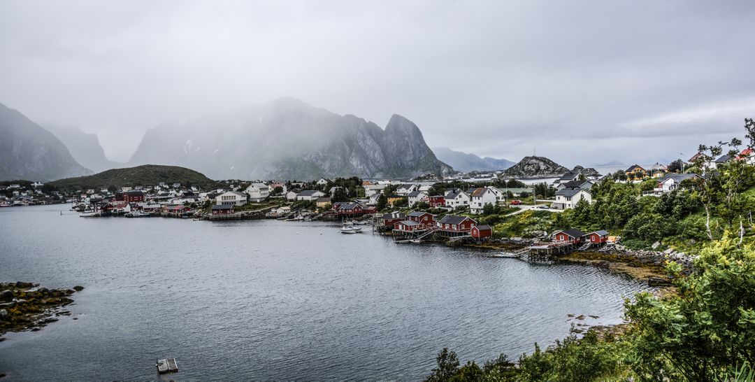 Scenic Village Overlooking Misty Fjord with Mountain Background - Free Images, Stock Photos and Pictures on Pikwizard.com