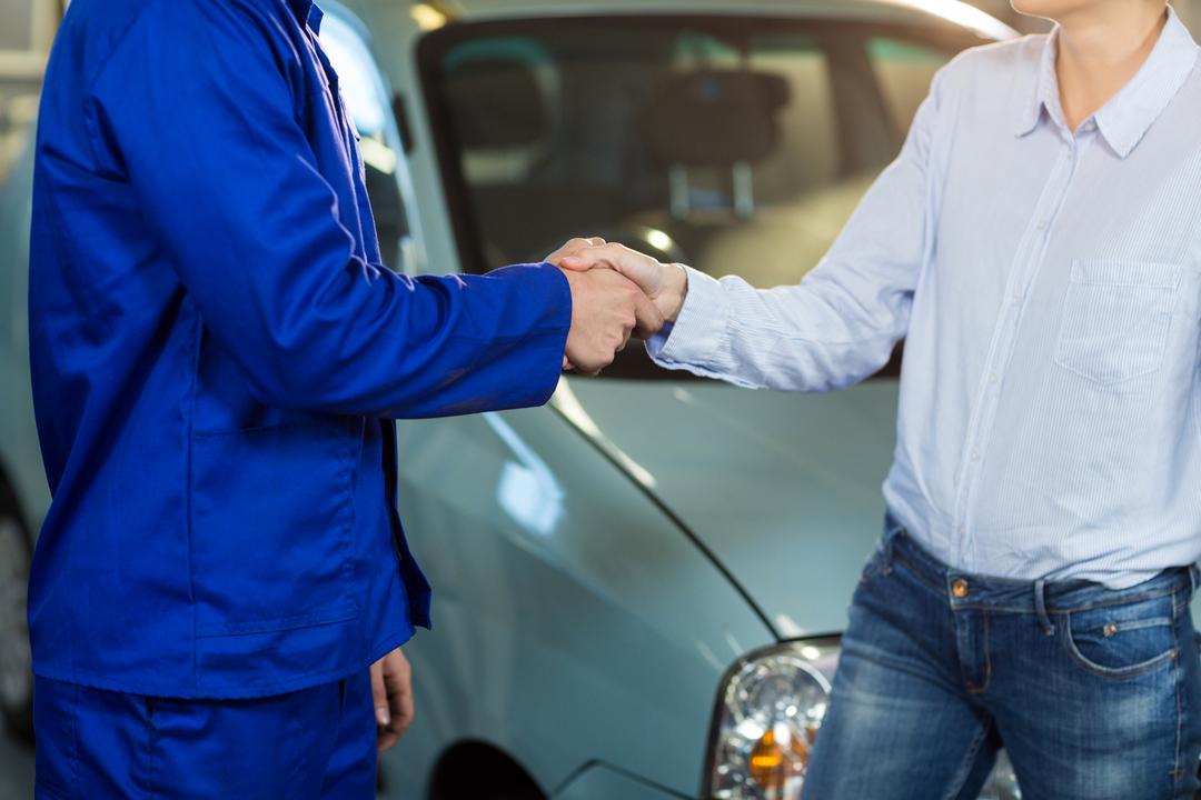 Mid-section of customer shaking hands with mechanic - Free Images, Stock Photos and Pictures on Pikwizard.com