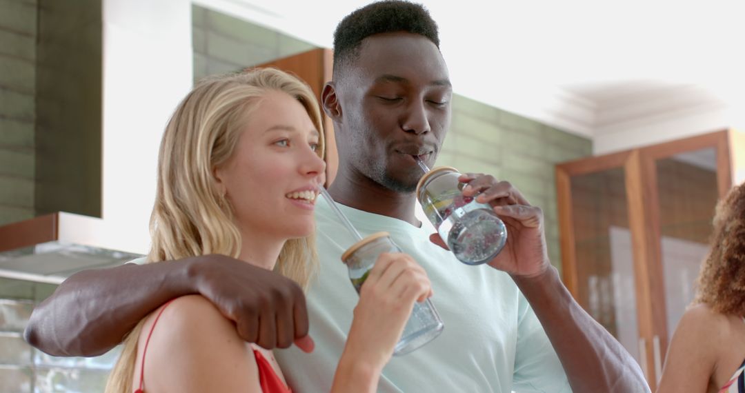 Friends Socializing Indoors with Refreshing Beverages