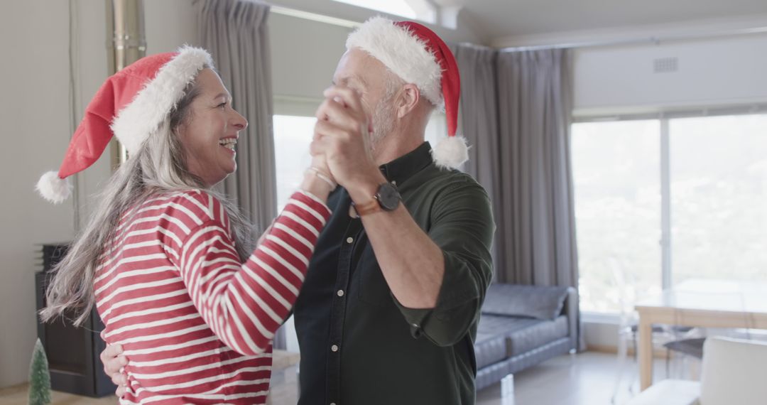 Happy Elderly Couple Dancing in Living Room Wearing Santa Hats - Free Images, Stock Photos and Pictures on Pikwizard.com