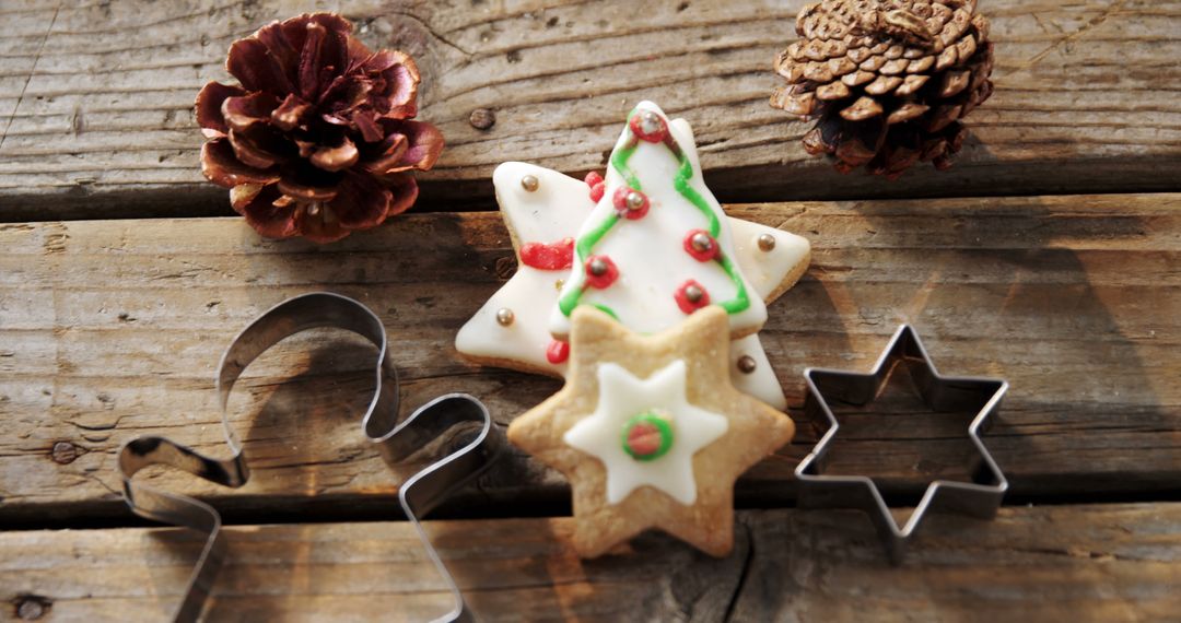 Festive Christmas Cookies with Pine Cones and Cutters on Rustic Wood - Free Images, Stock Photos and Pictures on Pikwizard.com