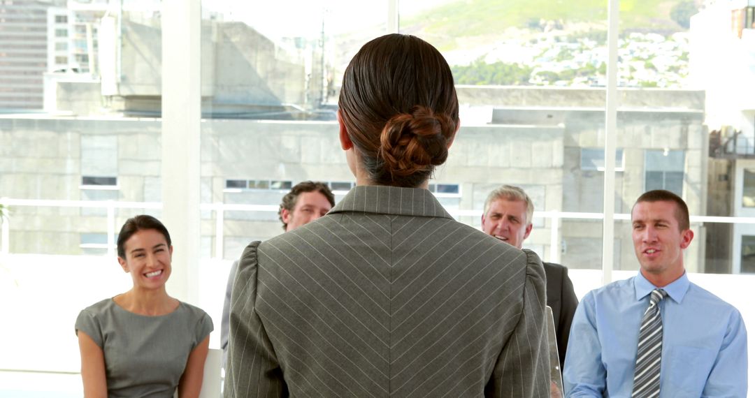 Businesswoman Leading Presentation to Diverse Business Team in Modern Office - Free Images, Stock Photos and Pictures on Pikwizard.com