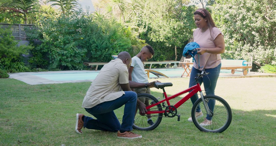 Father Teaching Son to Ride Bicycle in Sunny Backyard