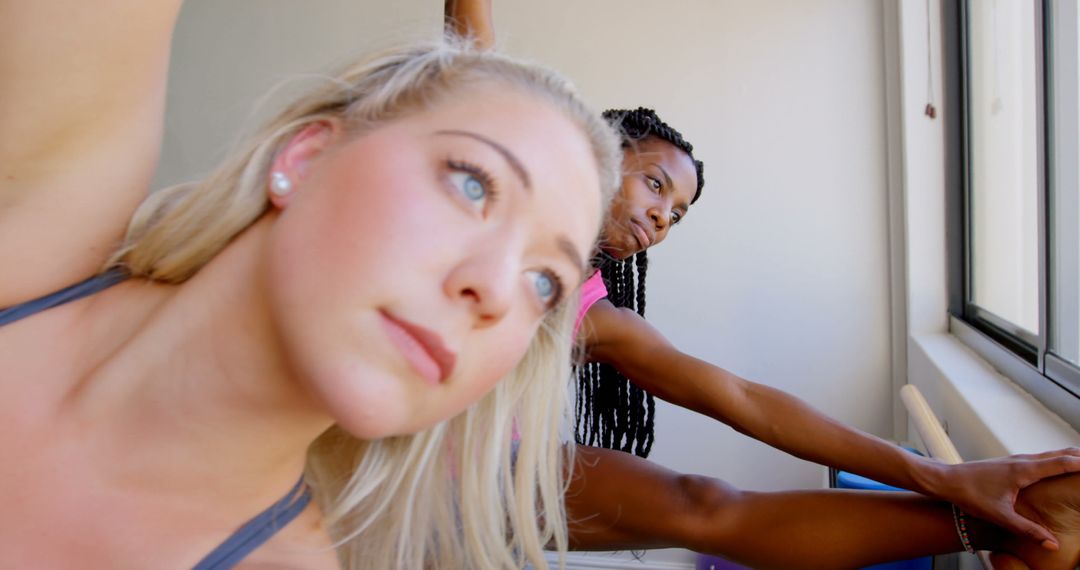Diverse Women Practicing Barre Exercises in Bright Gym Classroom