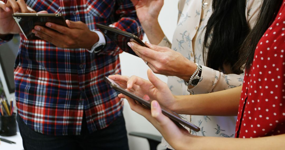Diverse Team Collaborating on Digital Tablets in Creative Workspace
