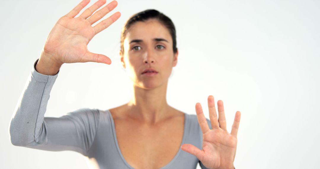 Young Woman Practicing Hand Movements in Bright Studio - Free Images, Stock Photos and Pictures on Pikwizard.com