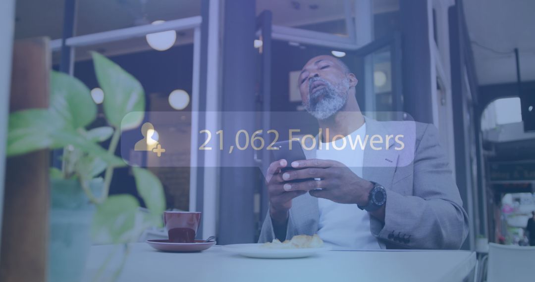 Man in Cafe Checking Social Media Follow Count