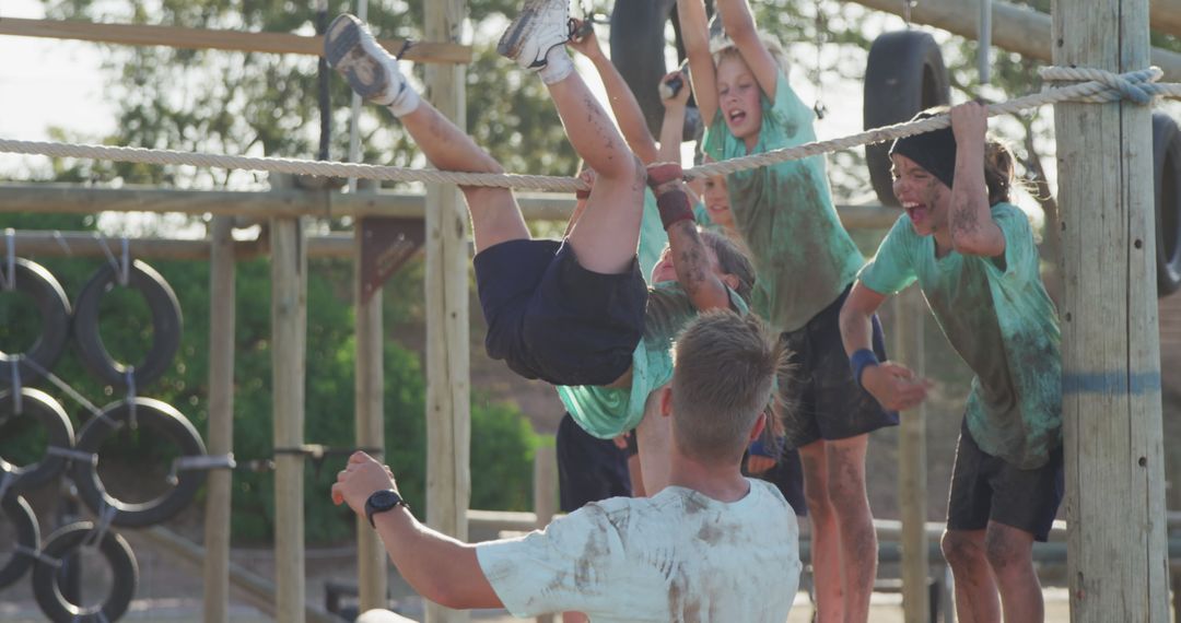 Kids Successfully Completing Rugged Outdoor Obstacle Course - Free Images, Stock Photos and Pictures on Pikwizard.com