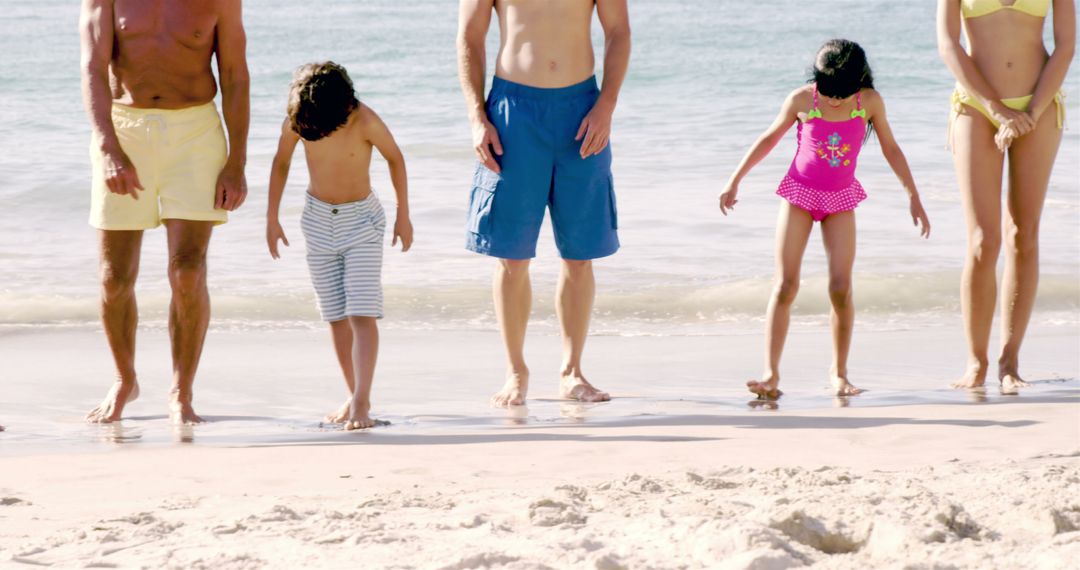 Family Standing at Beach Shoreline on Bright Sunny Day - Free Images, Stock Photos and Pictures on Pikwizard.com