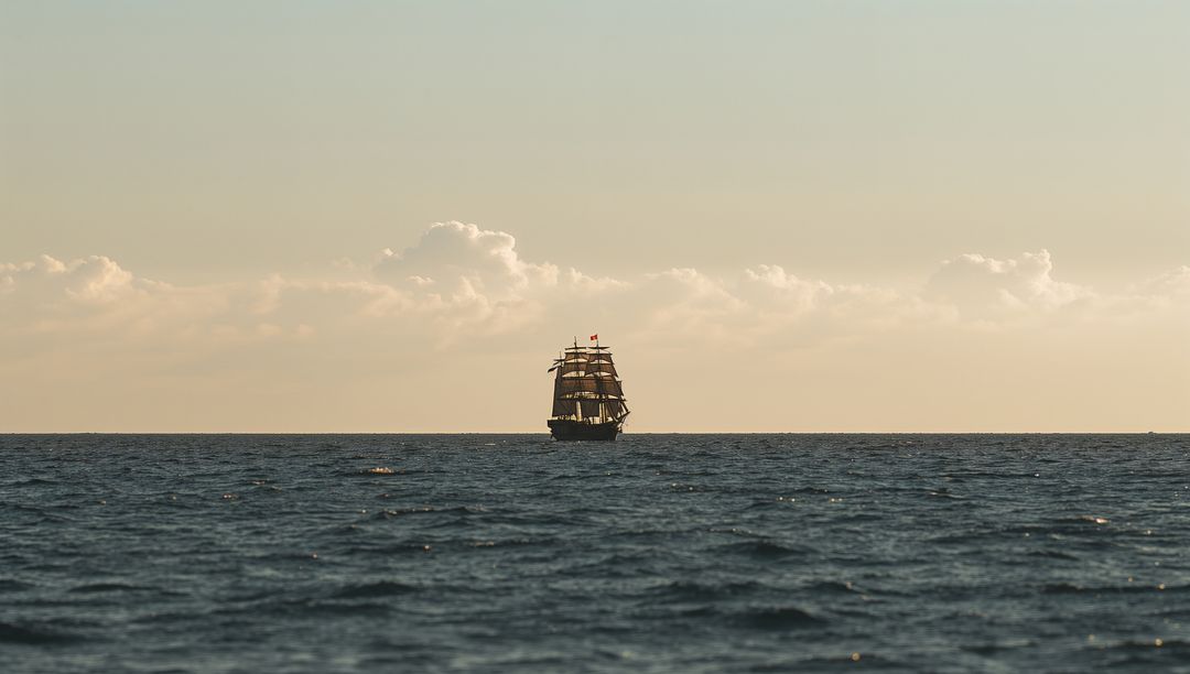 Majestic Three-Masted Ship Sailing on Open Ocean at Sunset