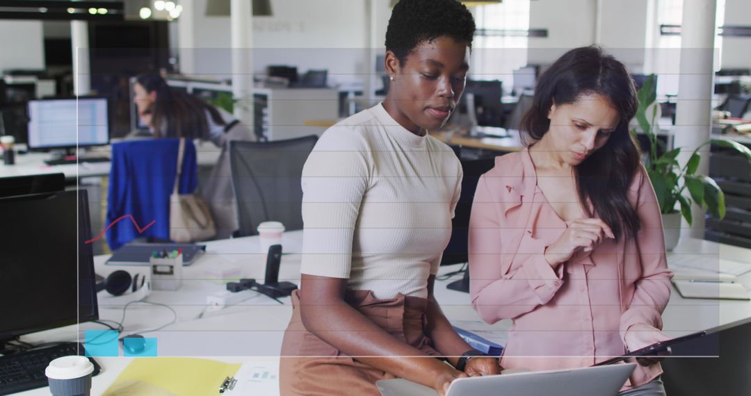 Diverse Women Collaborating on Business Data in Office