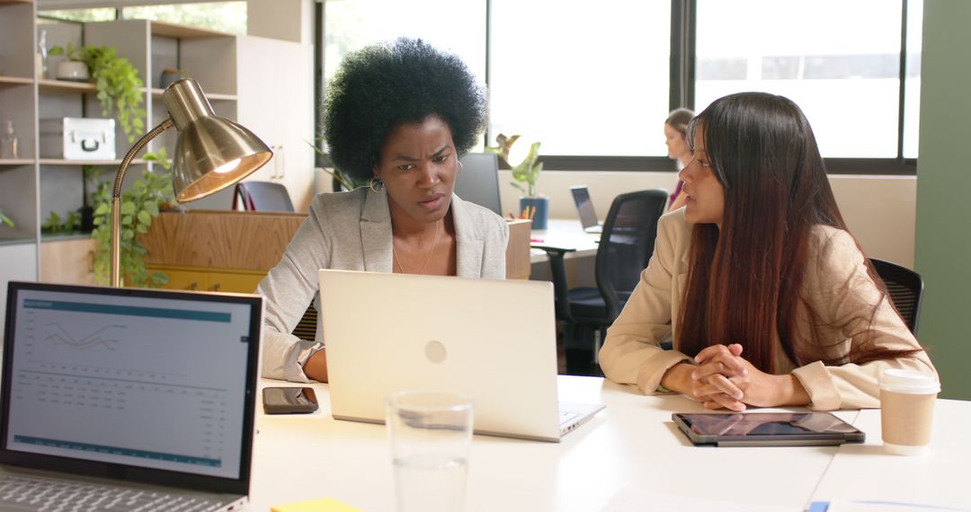 Two Businesswomen Collaborating on Project in Office - Free Images, Stock Photos and Pictures on Pikwizard.com