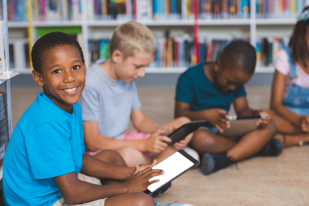 Diverse Kids Using Tablets in Library with Transparent Models