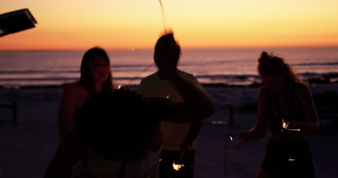 Friends Celebrating with Sparklers at Sunset Beach - Free Images, Stock Photos and Pictures on Pikwizard.com