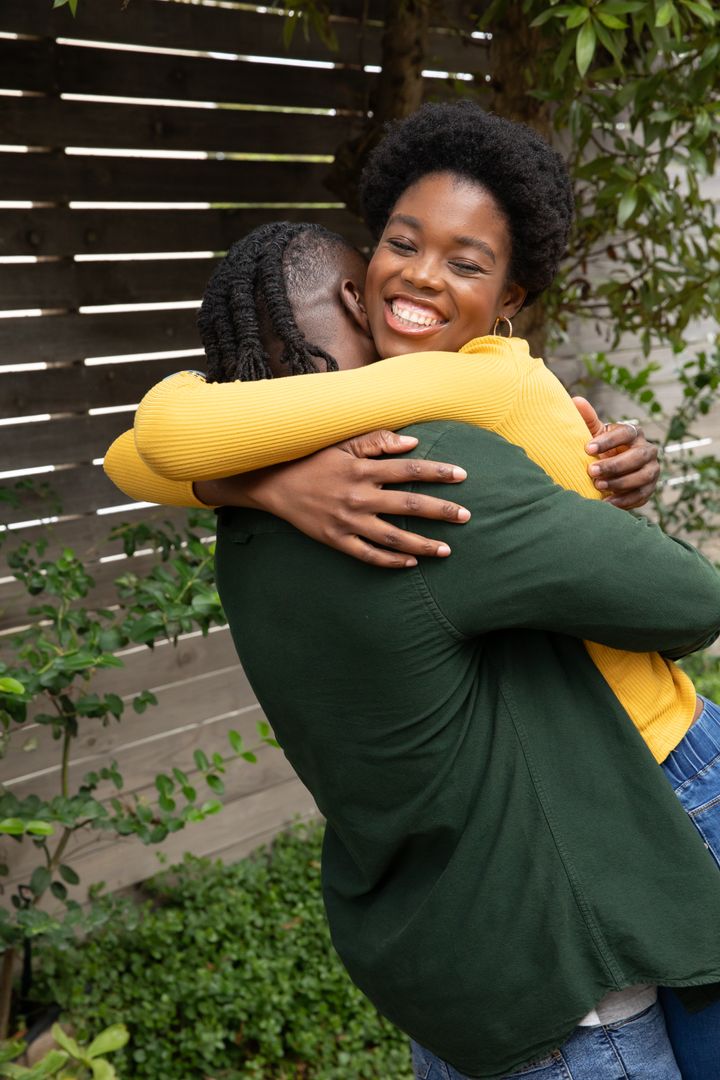Joyful Couple Embracing in Sunny Backyard Setting