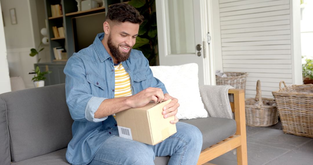 Man Relaxing on Patio Opening Parcel with Excitement