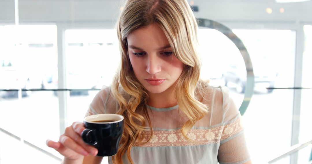 Woman Drinking Coffee in Relaxing Cafe Environment - Free Images, Stock Photos and Pictures on Pikwizard.com