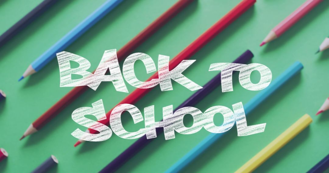 Colorful Pencils with Back to School Text on Green Background