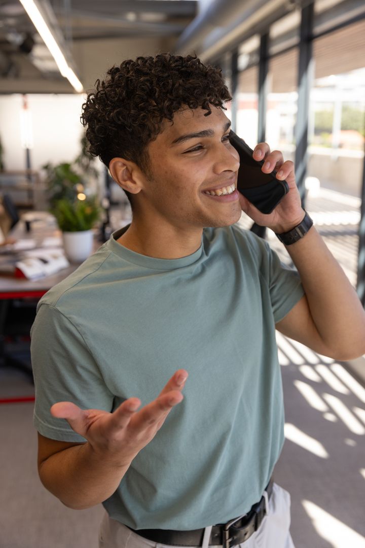 Cheerful Professional Engaging in Office Conversation on Phone