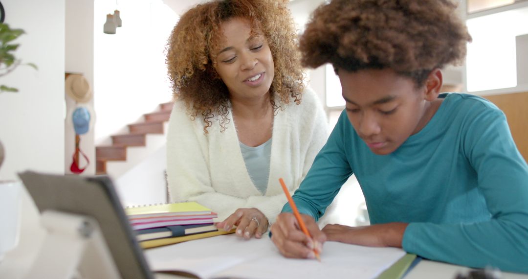 Mother Guiding Son with Homework at Home