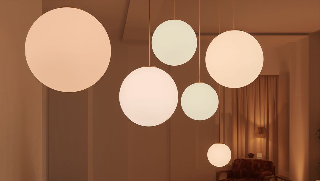 Cluster of Globe Pendant Lights Casting Warm Ambient Glow Over Minimalist Lounge Nook