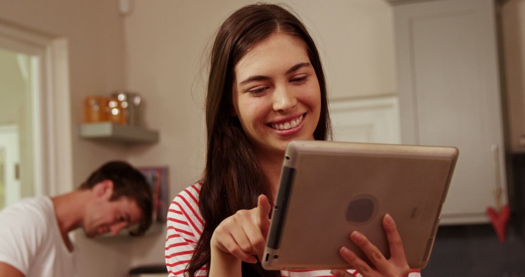 Young Woman Using Tablet in Modern Kitchen - Free Images, Stock Photos and Pictures on Pikwizard.com