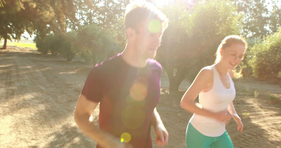 Young Couple Jogging in Summer Sunlight Outdoors - Free Images, Stock Photos and Pictures on Pikwizard.com