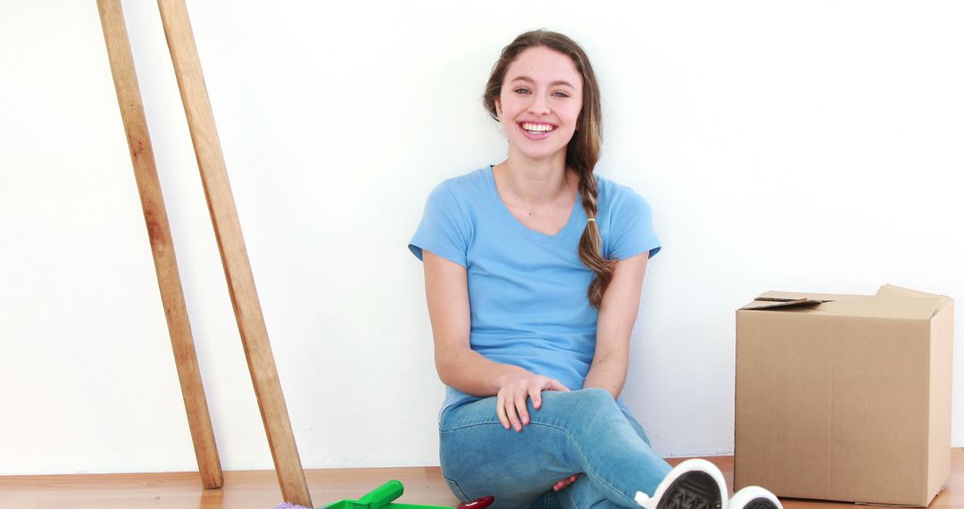 Woman Smiling While Taking a Break from Moving into New Home - Free Images, Stock Photos and Pictures on Pikwizard.com