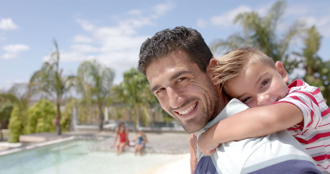 Joyful Father Carrying Son by Swimming Pool in Summer - Free Images, Stock Photos and Pictures on Pikwizard.com