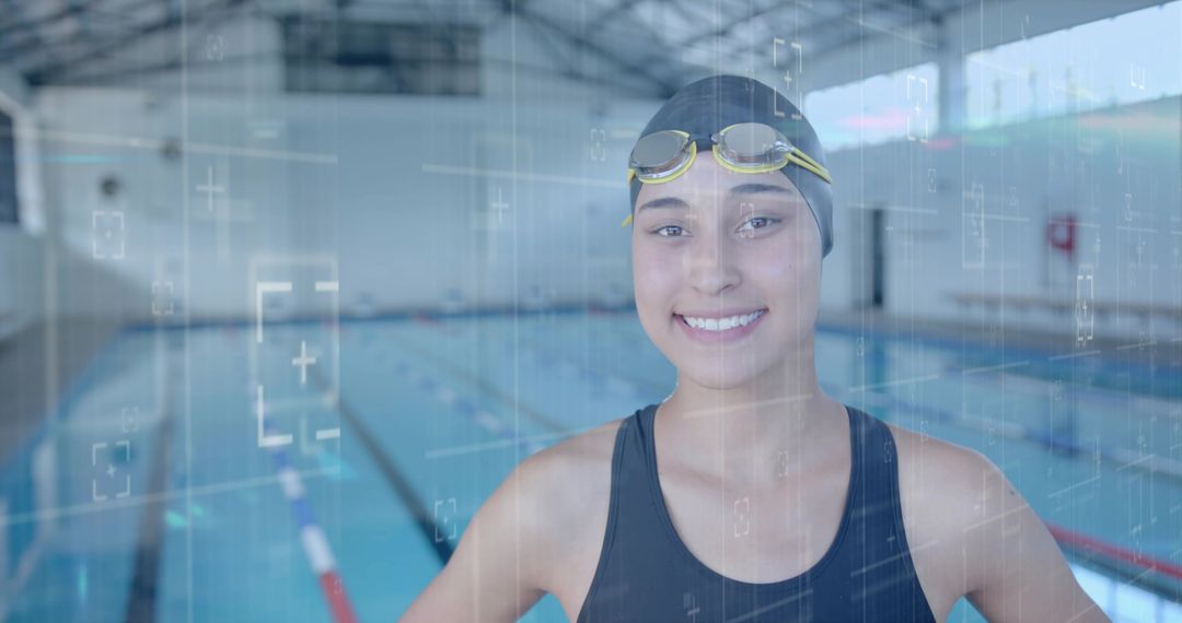 Smiling Swimmer with Goggles and Cap at Indoor Pool
