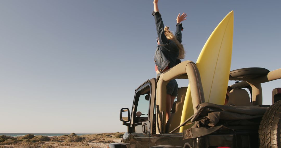 Woman Joyfully Standing in Convertible with Surfboard on Beach - Free Images, Stock Photos and Pictures on Pikwizard.com