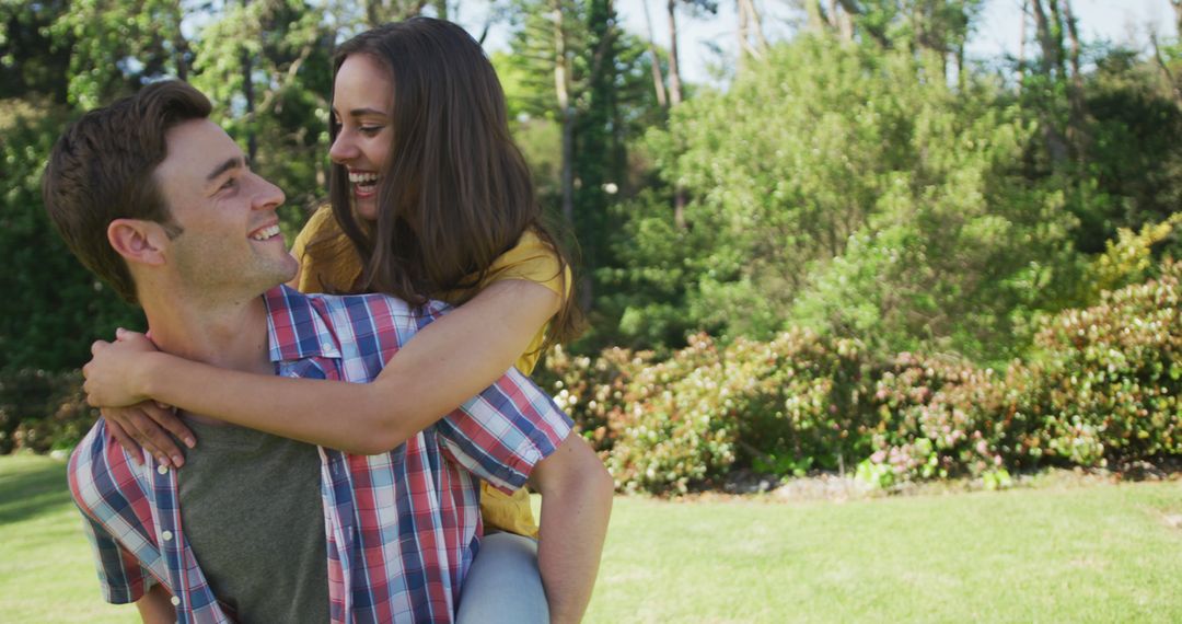 Joyful Couple Enjoying Playful Moment in Sunny Park