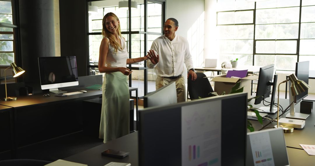 Colleagues Laughing and Collaborating in Modern Office Space