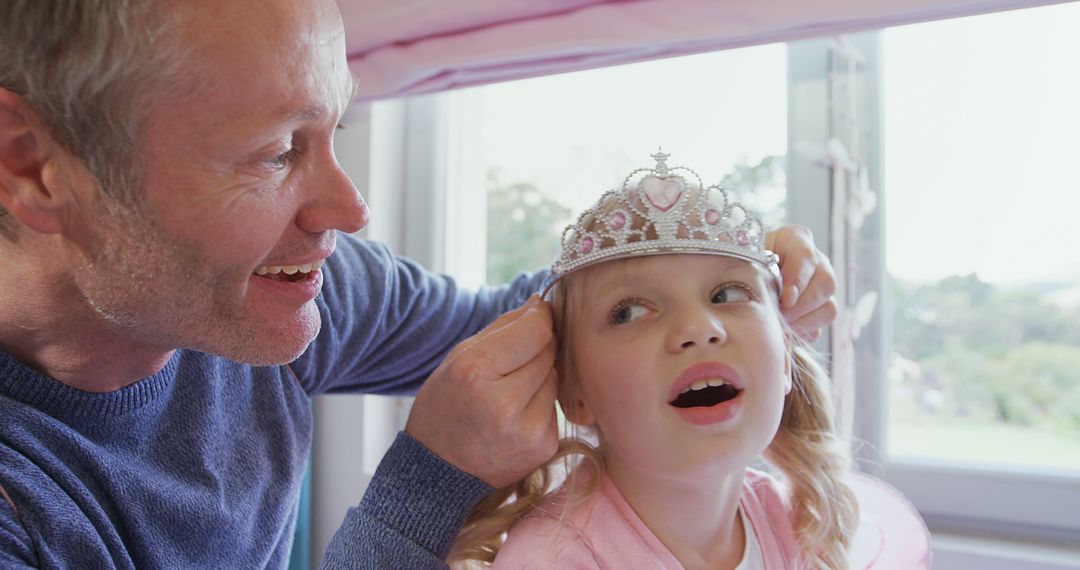 Father Adjusting Daughter's Princess Tiara at Home - Free Images, Stock Photos and Pictures on Pikwizard.com