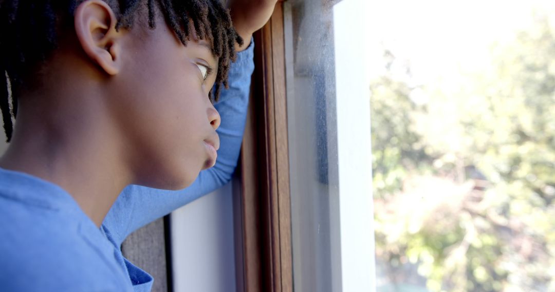 Pensive Black Boy Looking Through Window Thoughtfully - Free Images, Stock Photos and Pictures on Pikwizard.com