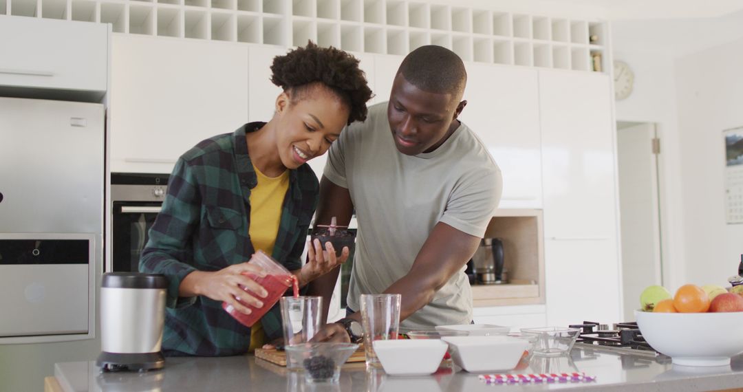 African American Couple Enjoying Juice Prep in Modern Kitchen