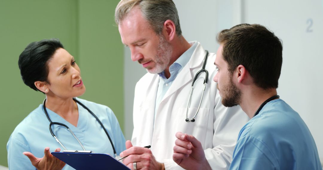 Group of Medical Professionals Discussing Patient Care in Hospital - Free Images, Stock Photos and Pictures on Pikwizard.com