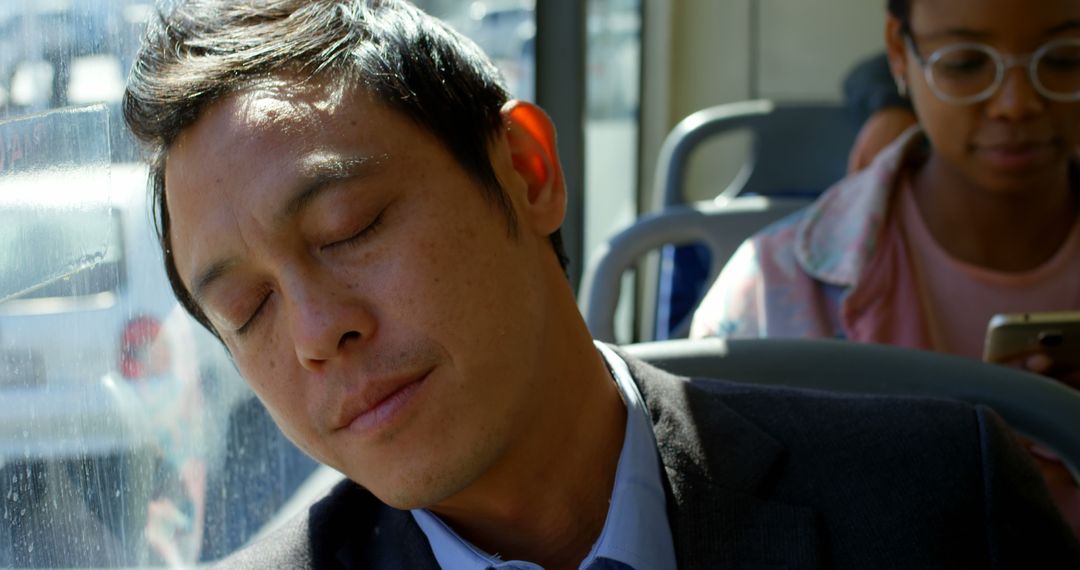 Tired Man in Business Suit Sleeping on Public Transport during Commute - Free Images, Stock Photos and Pictures on Pikwizard.com