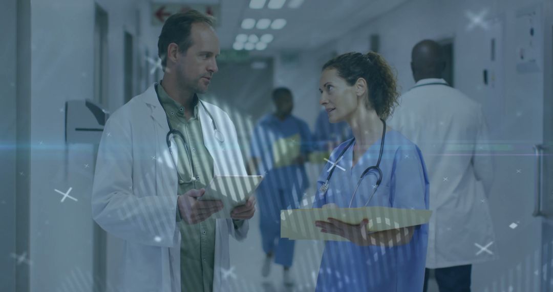 Healthcare Professionals Discussing Medical Records in Hospital Corridor