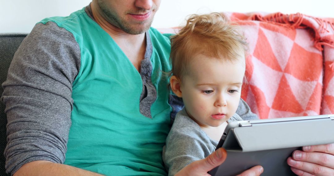 Father and Toddler Using Tablet Together at Home - Free Images, Stock Photos and Pictures on Pikwizard.com