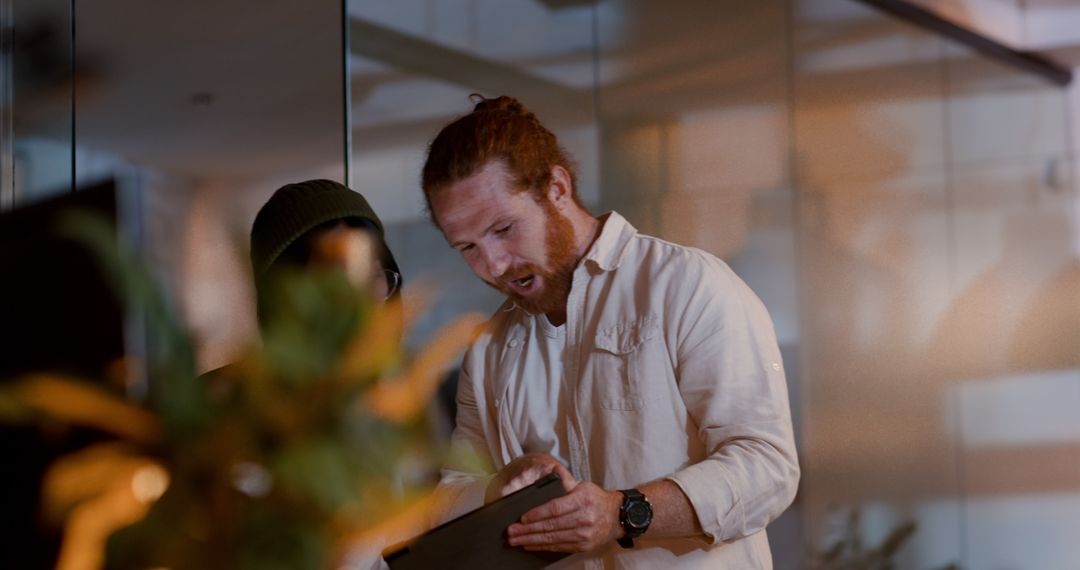 Focused Team Collaborating on Digital Project in Modern Office