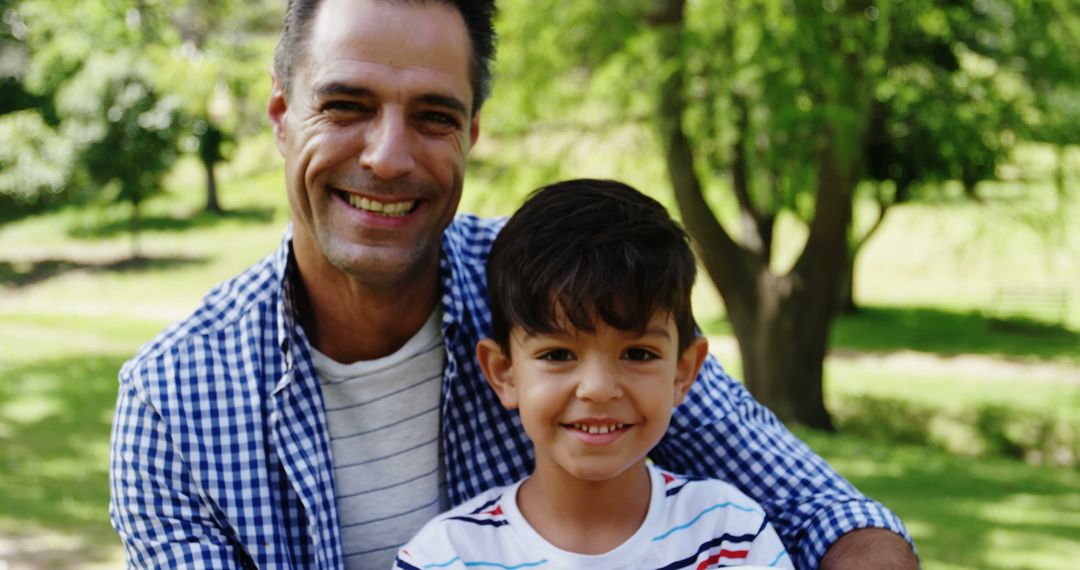 Happy Father and Son Smiling in Park on Sunny Day - Free Images, Stock Photos and Pictures on Pikwizard.com